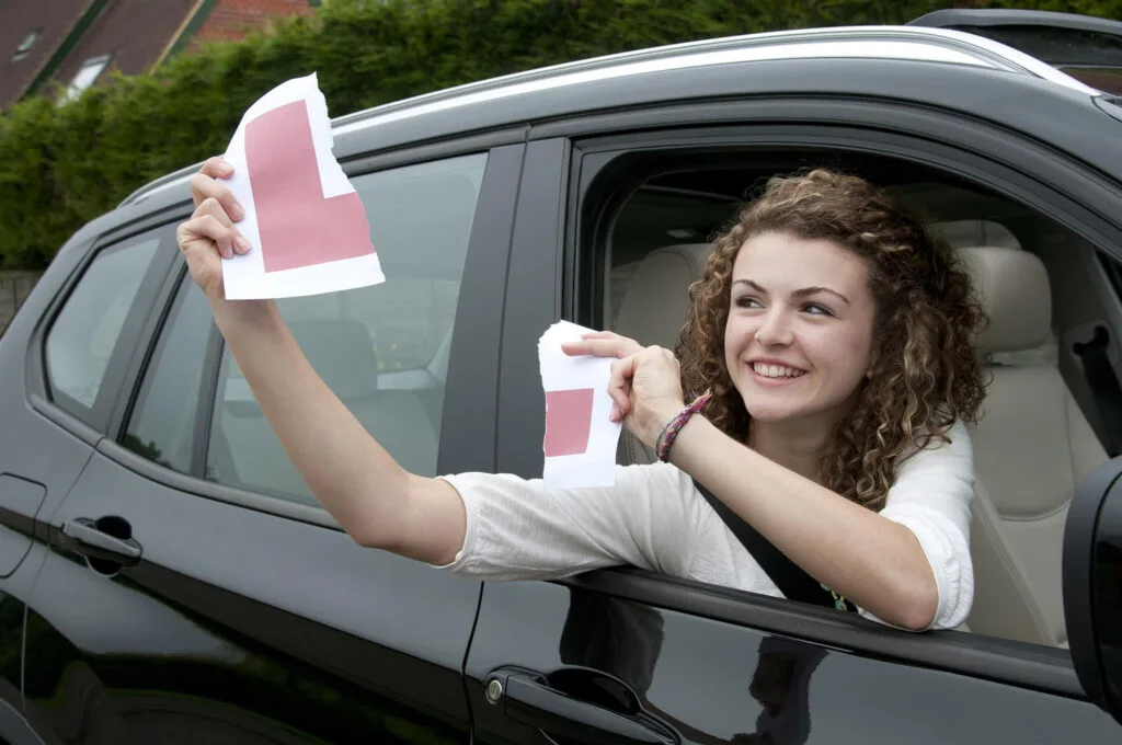 Woman ripping up L sign as she has passed with PassClub Unlimited Package